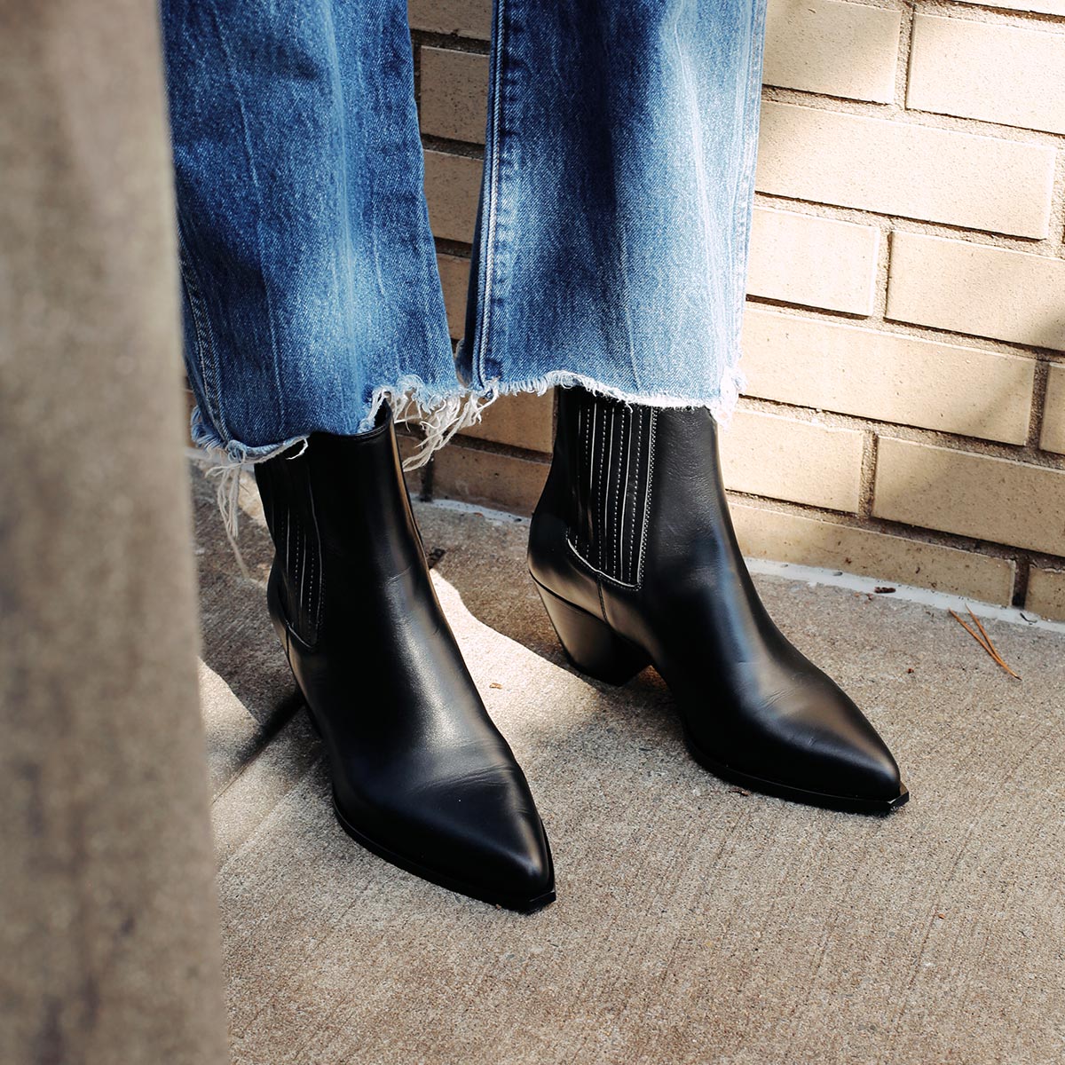 The Agnes Boot in Black Calf, featuring a sleek design inspired by classic Western styles, crafted from high-quality leather with a squared-off toe and angular heel.