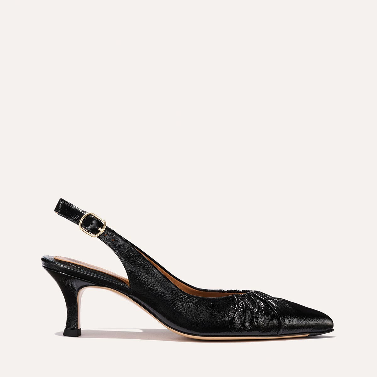 The Anya Slingback in shiny Black Crinkle-Gloss Nappa, featuring a ruched tapered toe with an adjustable buckle and a comfortable 2.5-inch black heel.