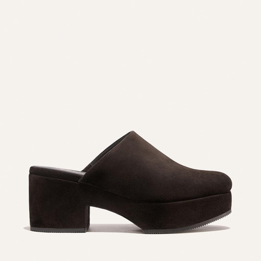 The Alison Roman x Margaux: The Atlantic Clog in Dark Chocolate Suede by Margaux, a closed-toe platform mule with a chunky block heel, is shown in profile against a plain light background.