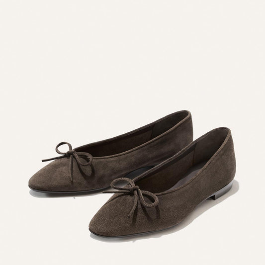The Alison Roman x Margaux: The Salamanca - English Brown Suede flats feature pointed toes and front bows, shown on a plain white background.