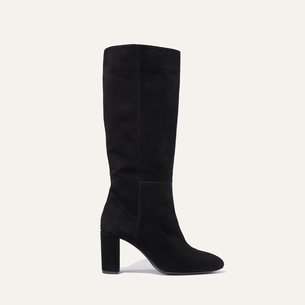 Margaux's knee-high Bleecker Boot in soft, black Italian suede with walkable heel and almond-shaped toe
