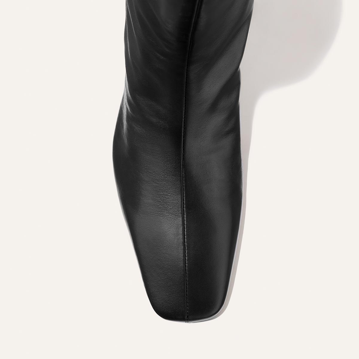 Close-up top view of the Margaux Brera Boot in Black Nappa leather, featuring a square toe, on a light background.