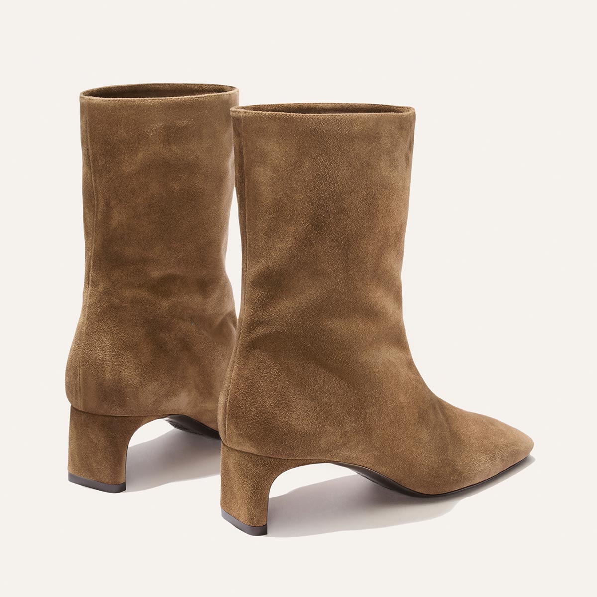 The Brera Boot in Driftwood Suede by Margaux, featuring mid-height block heels, is displayed on a plain light background.