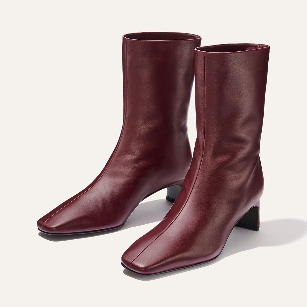 Margaux The Brera Boot - Merlot Calf: dark red calf-length square toe boots with a low 2″ block heel and a padded insole.