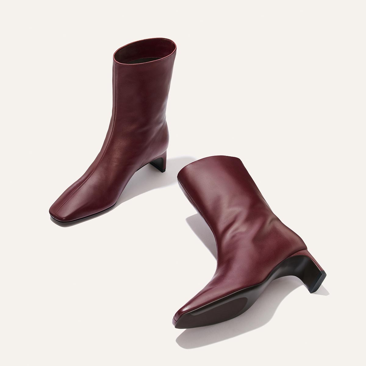 The Brera Boot - Merlot Calf is a dark red calf-length boot with a square toe, a padded insole, and a 2″ block heel.