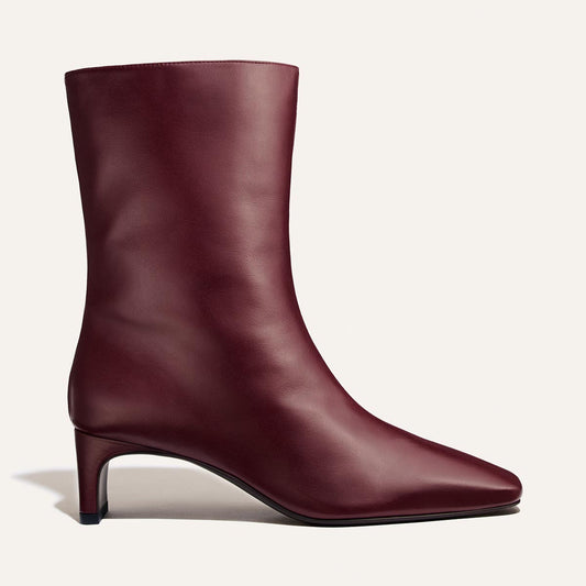 The Brera Boot - Merlot Calf is a deep red leather ankle boot with a square toe, a padded insole, and a 2″ kitten heel.