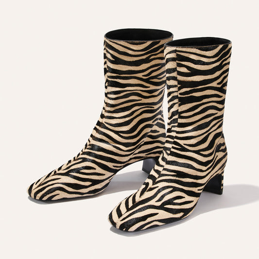 The Brera Boot - Tan Zebra Haircalf mid-calf square toe boots featuring a black and tan zebra print pattern and 2″ block heels.