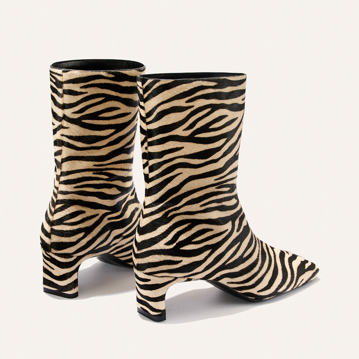Margaux The Brera Boot - Tan Zebra Haircalf ankle boots with a square toe and 2″ kitten heels in tan and black zebra stripes.
