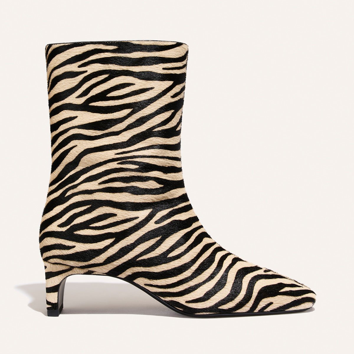The Brera Boot - Tan Zebra Haircalf square-toe ankle boot in a tan and black zebra print with a 2″ kitten heel.