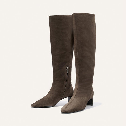 The Brera Knee-High Boot by Margaux, shown in English Brown Suede, features a comfortable mid-height block heel, side zippers for easy wear, and a padded insole for enhanced comfort, all displayed against a plain white background.