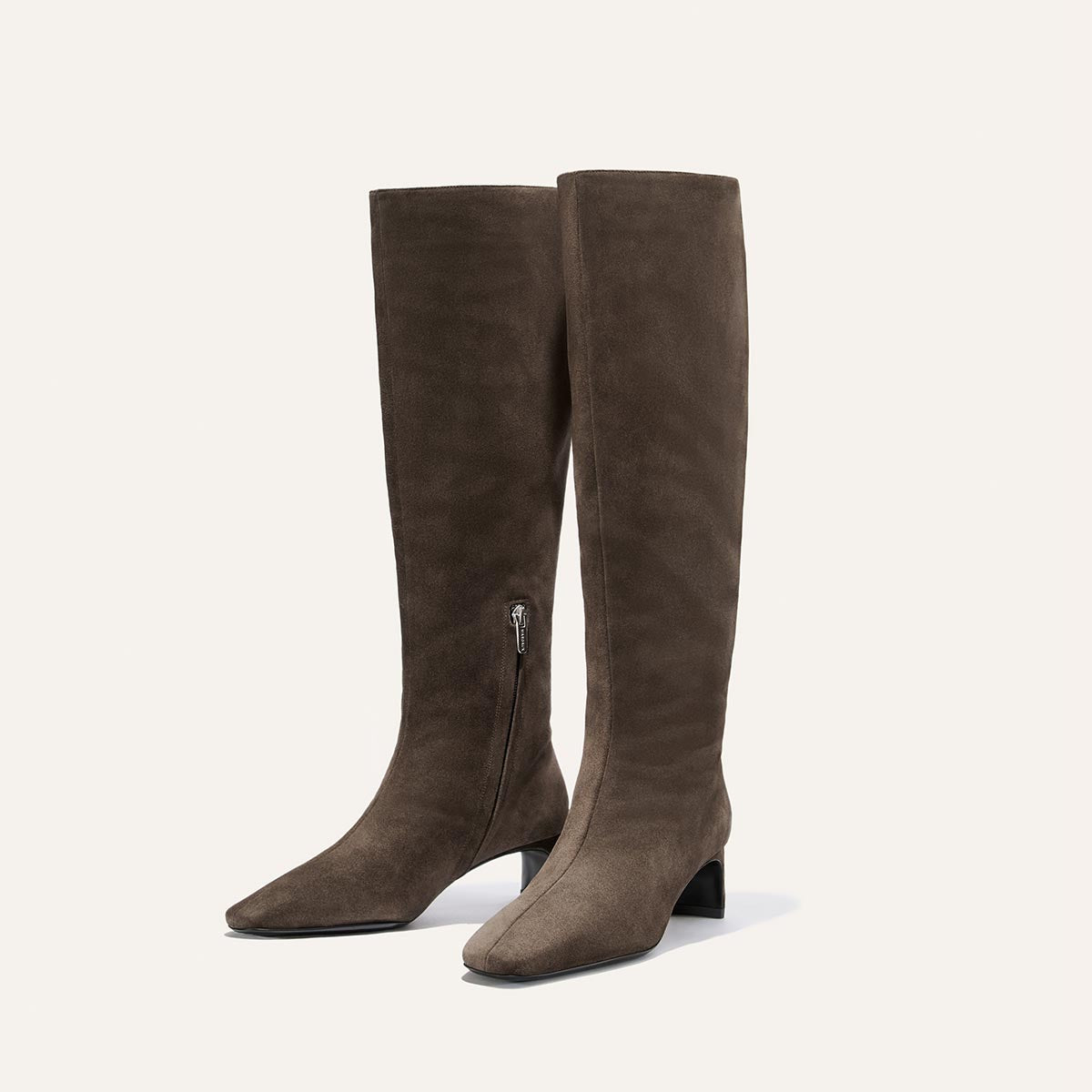 The Brera Knee-High Boot in English Brown Suede by Margaux features low, walkable block heels, padded insoles for extra comfort, and side zippers, shown against a plain light background.