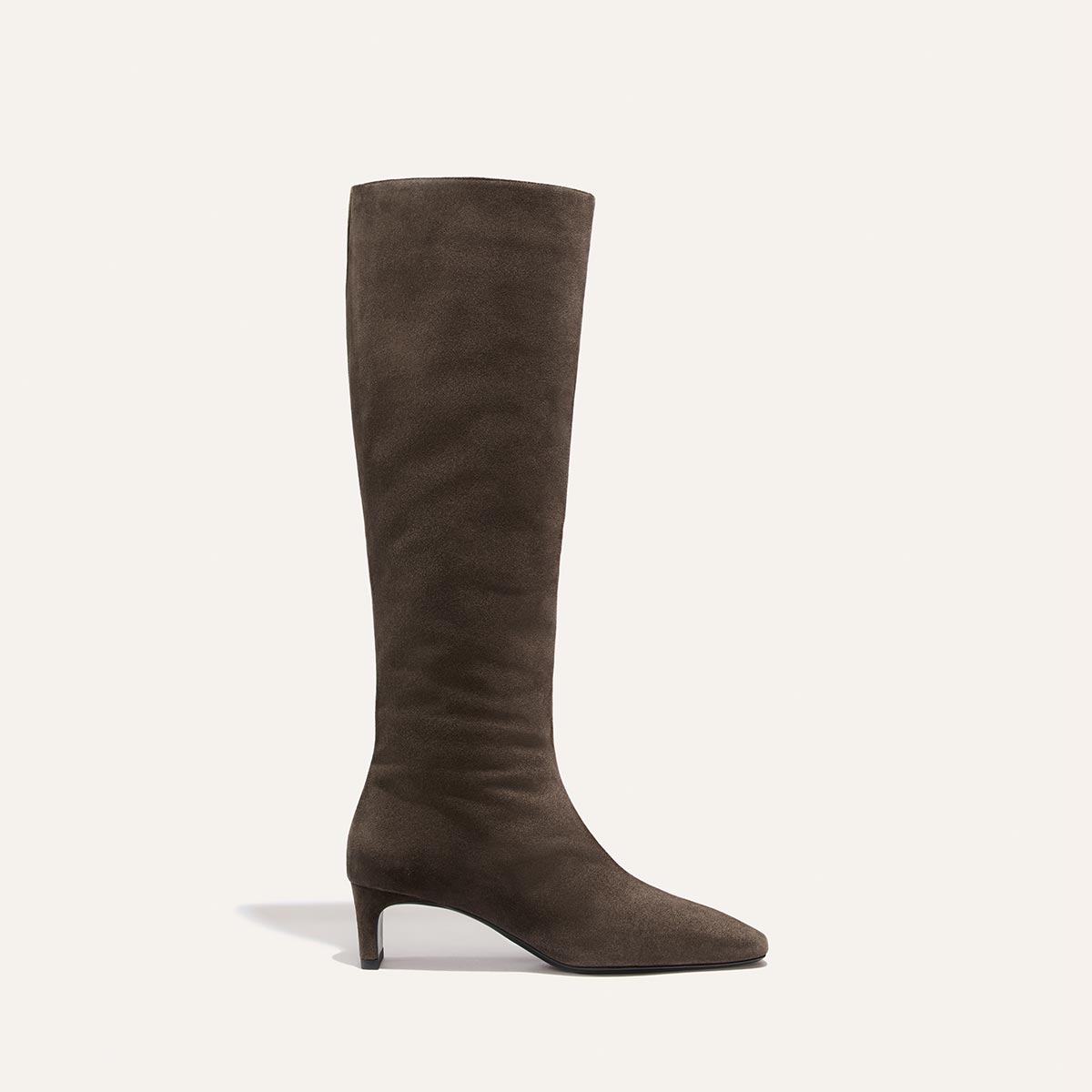 The Brera Knee-High Boot in English Brown Suede from Margaux is shown in profile against a plain light background, displaying its tall silhouette and low, walkable heel.