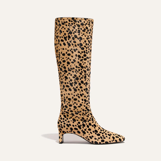 The Brera Knee-High Boot - Tan Cheetah Haircalf features a tan and black animal print, a walkable kitten heel, and a padded insole.