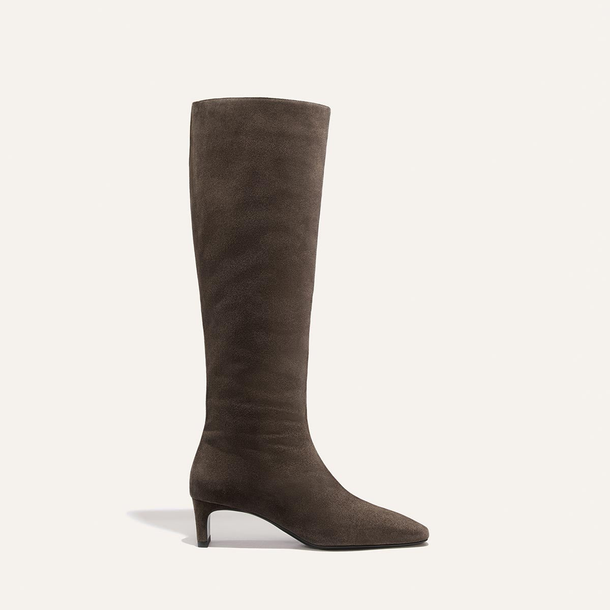 The Brera Knee-High Boot in English Brown Suede featuring a pointed toe and a walkable kitten heel.