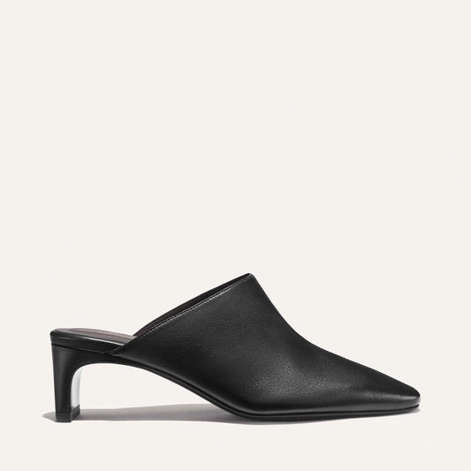 The Brera Mule - Black Nappa by Margaux, featuring a pointed toe and mid-height heel, is displayed in a side profile view against a plain, light background.
