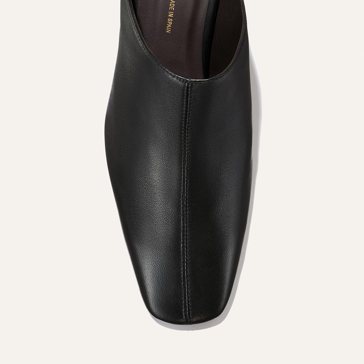 Top view of a single Margaux “The Brera Mule” in black nappa leather with a square toe, shown against a plain light background.