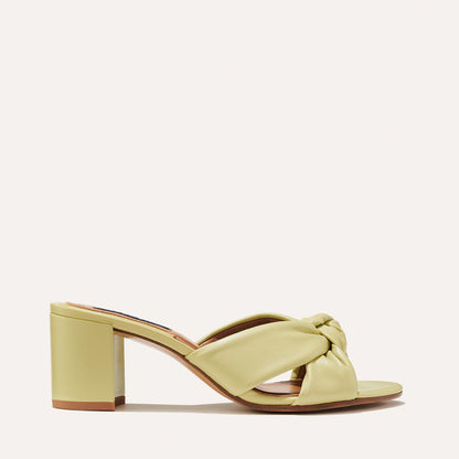 The Carmine Mule in Pear Nappa, a slide-on heel featuring a plush knot detail and comfortable 2.5-inch block heel