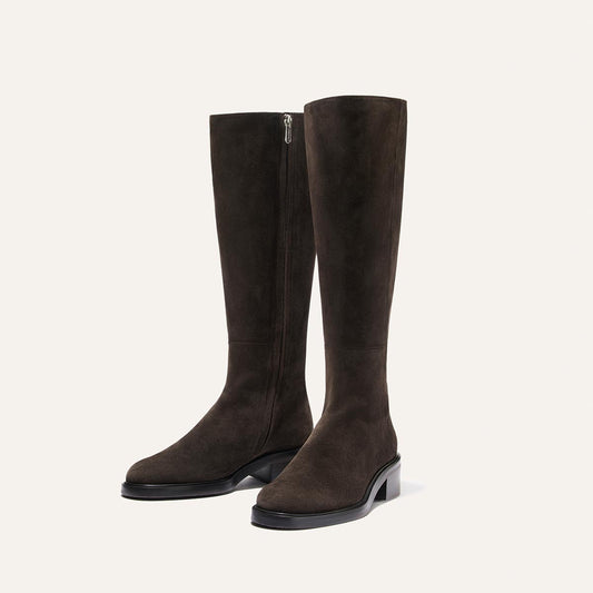 Margaux The City Boot - Dark Chocolate Suede, a knee-high riding boot in dark brown suede with a side zipper, a low block heel, and a classic silhouette.