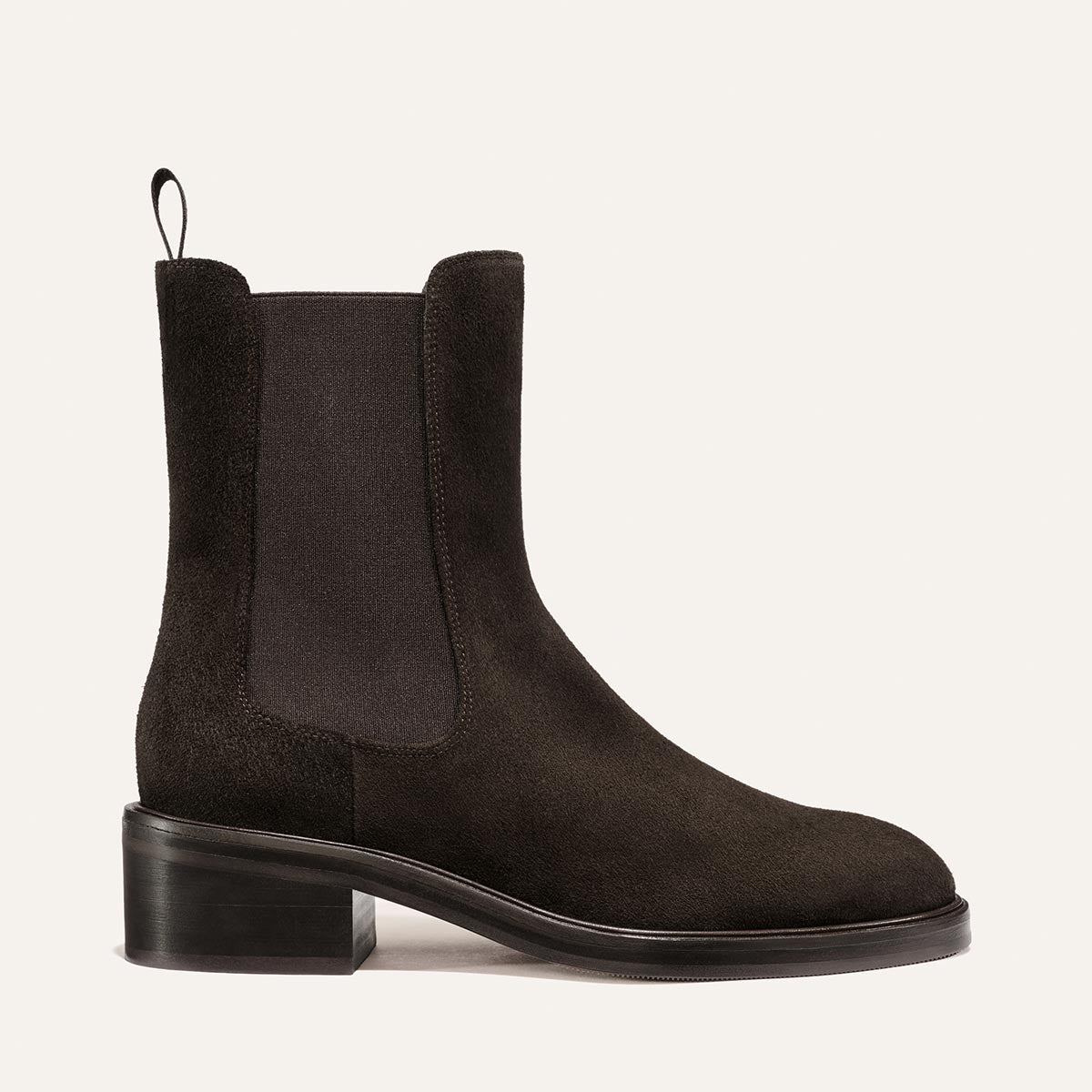The City Chelsea Boot - Dark Chocolate Suede by Margaux, featuring a block heel, elastic side panels, a back pull tab, and a smooth sole, is displayed on a neutral background.