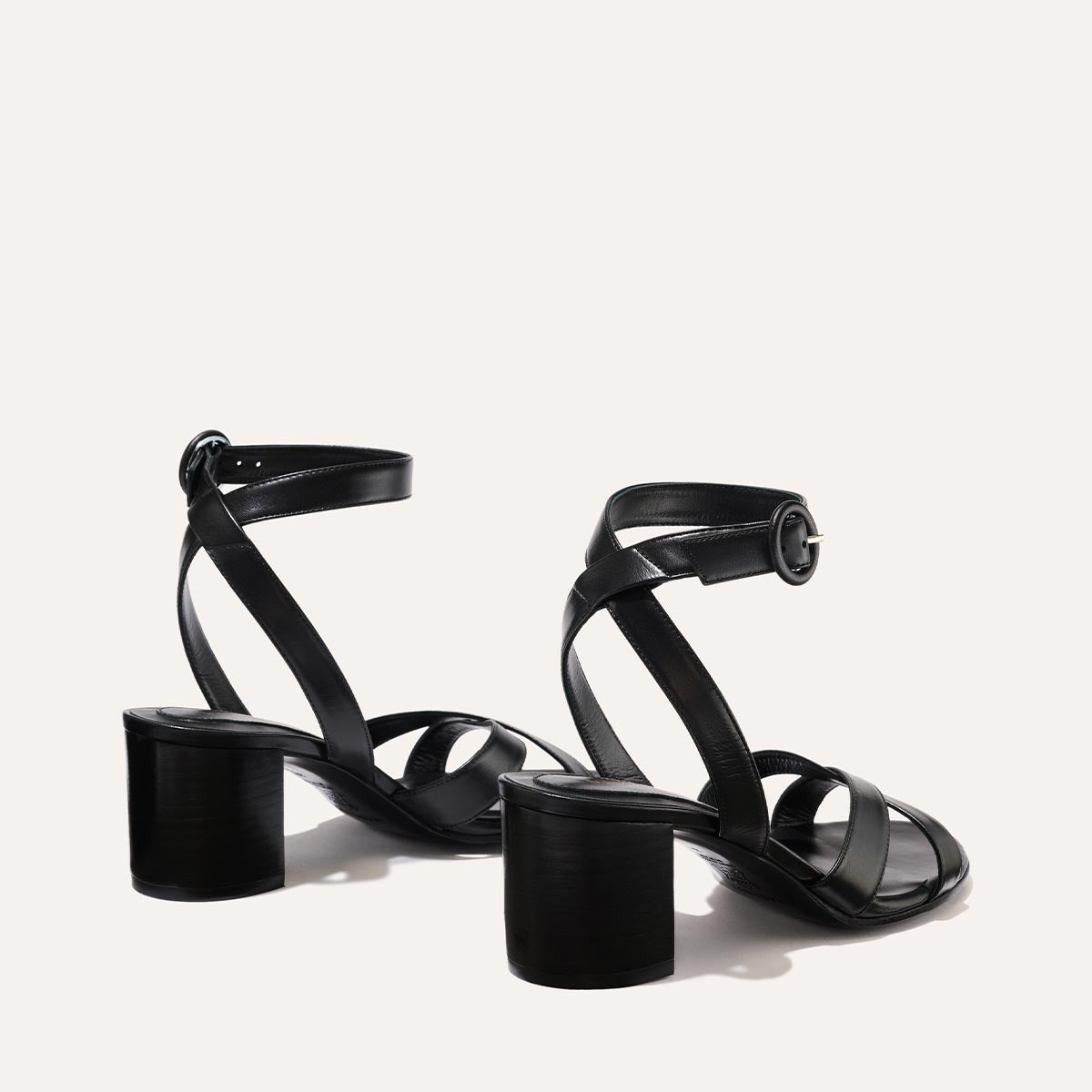 The City Sandal in Black Nappa, featuring carefully placed straps, an adjustable ankle strap and a comfortable 2.5-inch block heel.