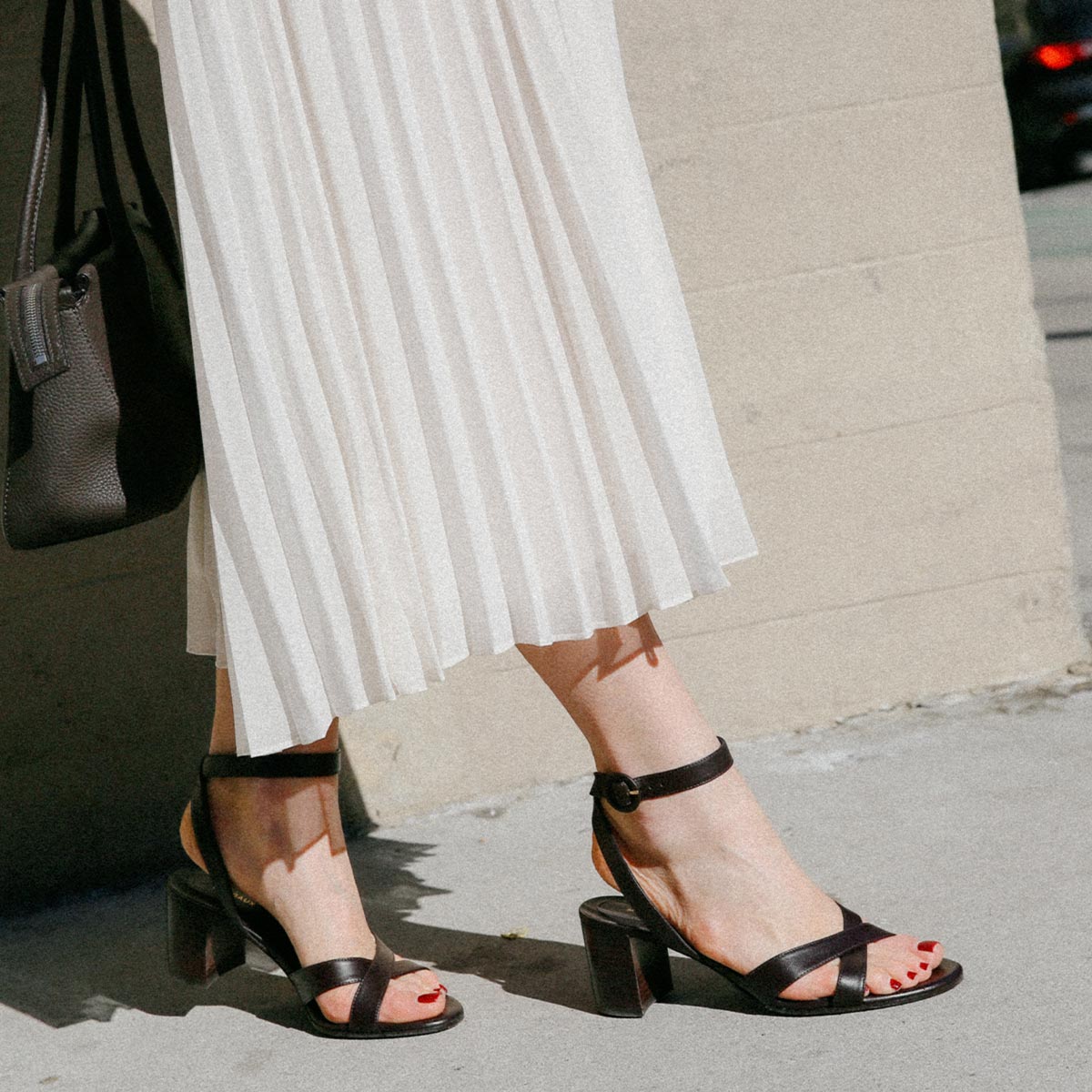 The City Sandal in Espresso Nappa, featuring carefully placed straps, an adjustable ankle strap and a comfortable 2.5-inch block heel.