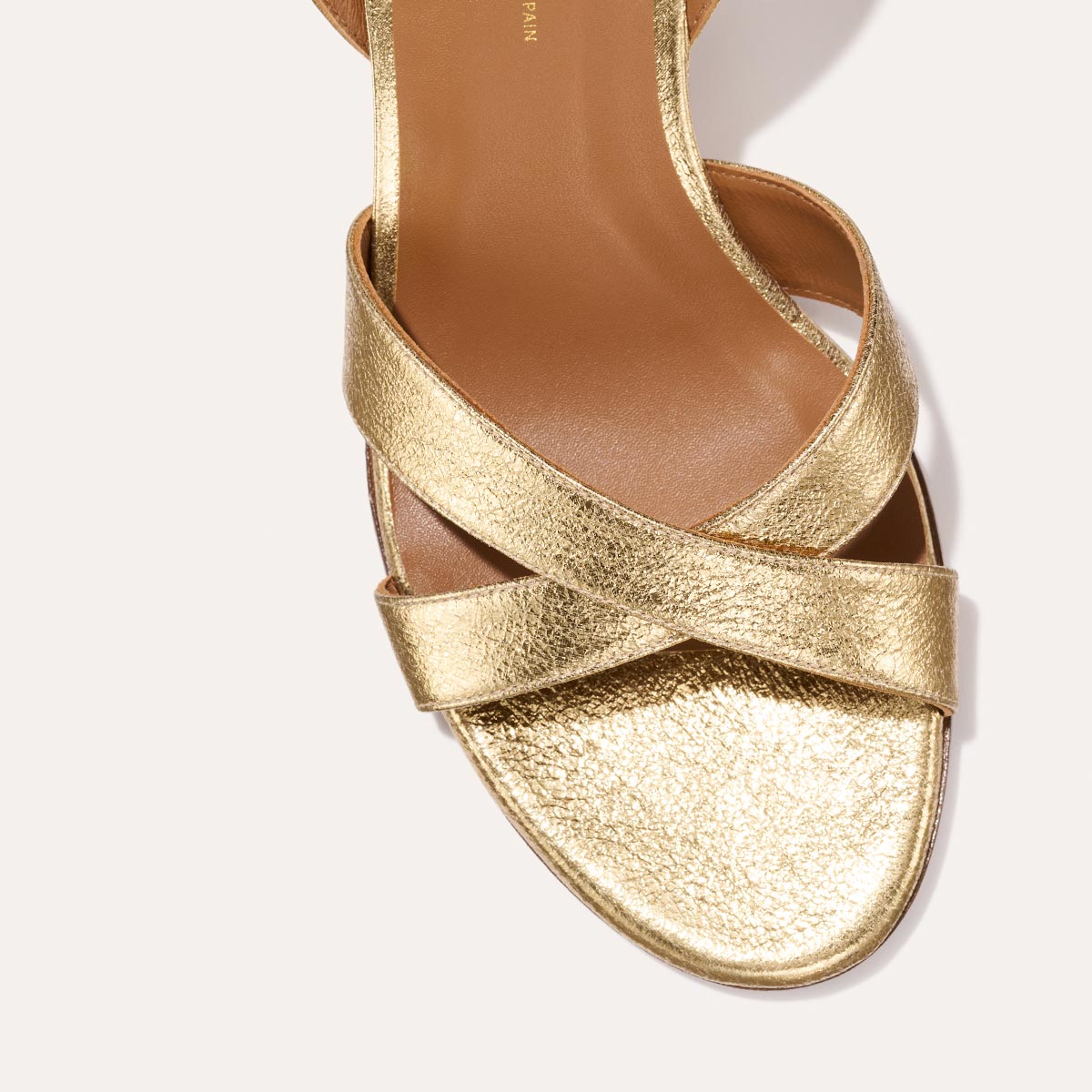 The City Sandal in shiny Gold Crinkle Nappa, featuring carefully placed straps, an adjustable ankle strap and a comfortable 2.5-inch block heel.