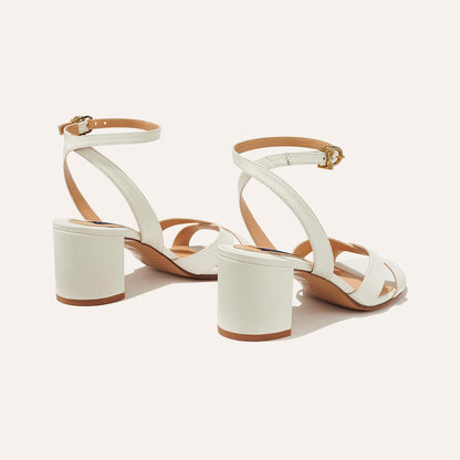 The City Sandal in Ivory Nappa, featuring carefully placed straps, and adjustable ankle strap and a comfortable 2.5-inch block heel.