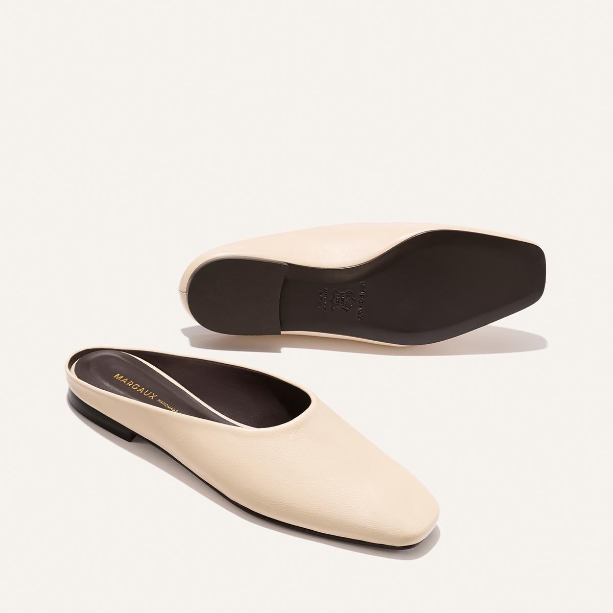 Pair of white shoes with black soles on a white background