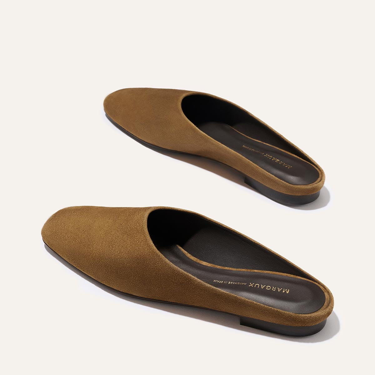 The Clara - Cedar Suede by Margaux: brown suede closed-toe slip-on mules with a flat black sole, shown on a light background.