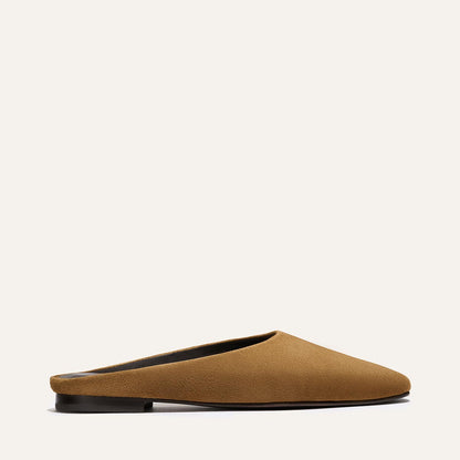 The Clara - Cedar Suede by Margaux: a brown suede slip-on mule with a flat black sole, shown in side profile against a plain off-white background.