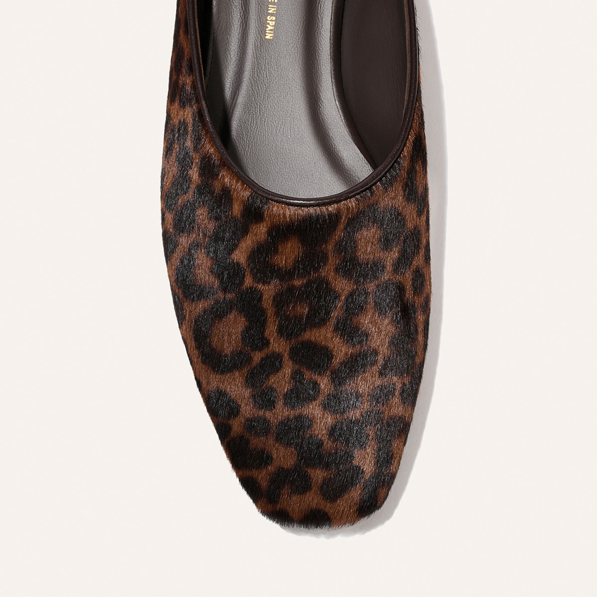 A close-up of The Clara - Chocolate Leopard Haircalf by Margaux, a square-toe flat slipper crafted in textured, fur-like chocolate leopard print—an effortlessly chic do-it-all style.