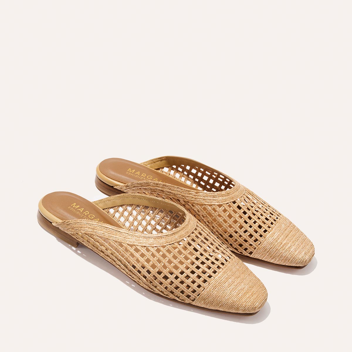 Pair of woven sandals on a white background