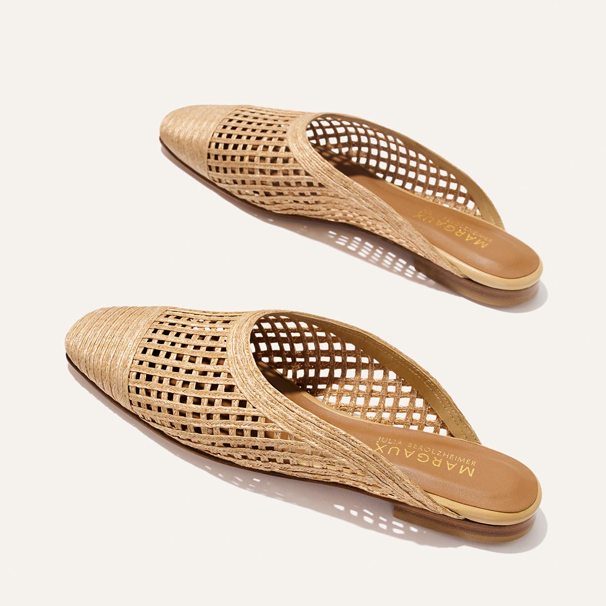 Pair of woven mules on a white background