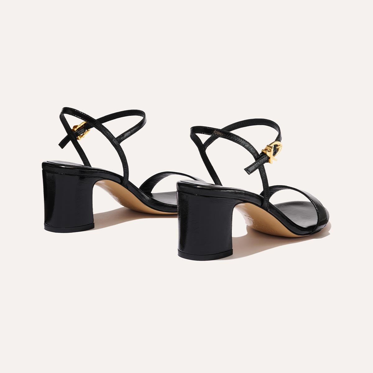 The Cleo Sandal in Black Crinkle-Gloss Nappa, a comfortable 2.5-inch heeled sandal with a sleek strap across the toes and perfectly placed instep strap.