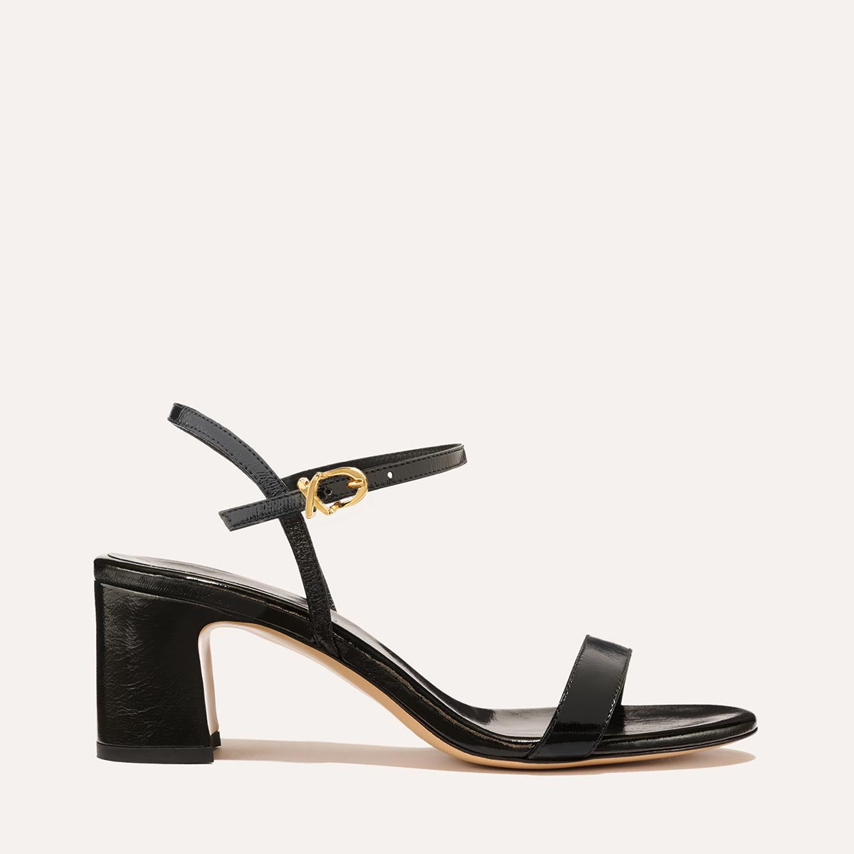 The Cleo Sandal in Black Crinkle-Gloss Nappa, a comfortable 2.5-inch heeled sandal with a sleek strap across the toes and perfectly placed instep strap.