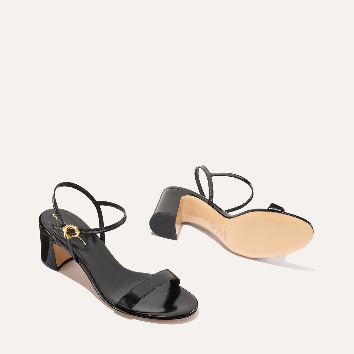 The Cleo Sandal in Black Crinkle-Gloss Nappa, a comfortable 2.5-inch heeled sandal with a sleek strap across the toes and perfectly placed instep strap.