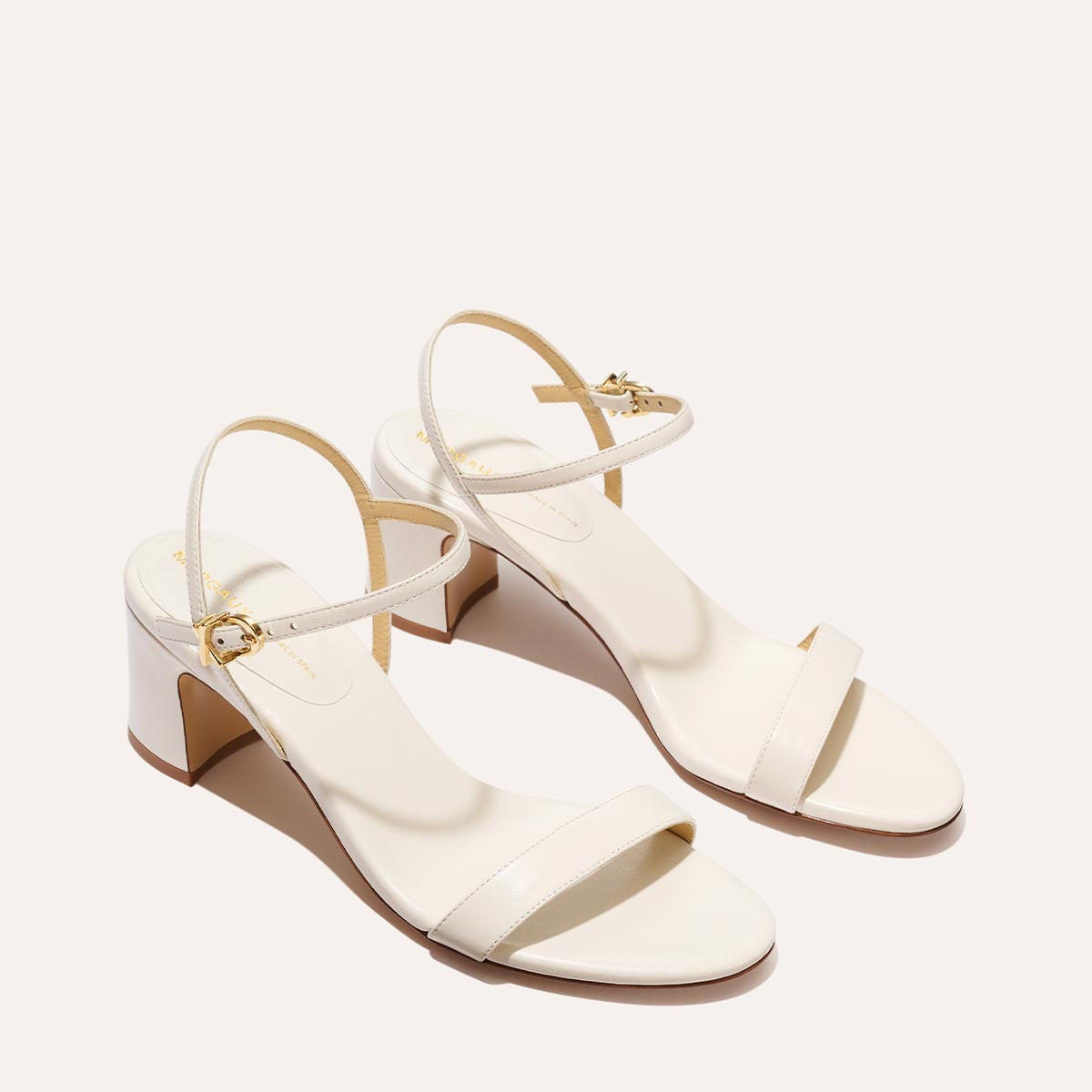 The Cleo Sandal in Ivory Nappa, a comfortable 2.5-inch heeled sandal with a sleek strap across the toes and perfectly placed instep strap.