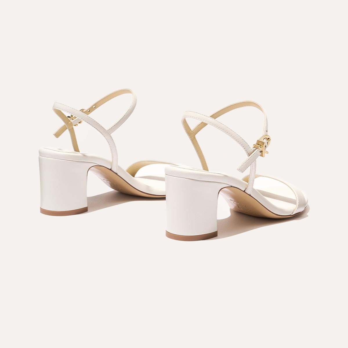 The Cleo Sandal in Ivory Nappa, a comfortable 2.5-inch heeled sandal with a sleek strap across the toes and perfectly placed instep strap.