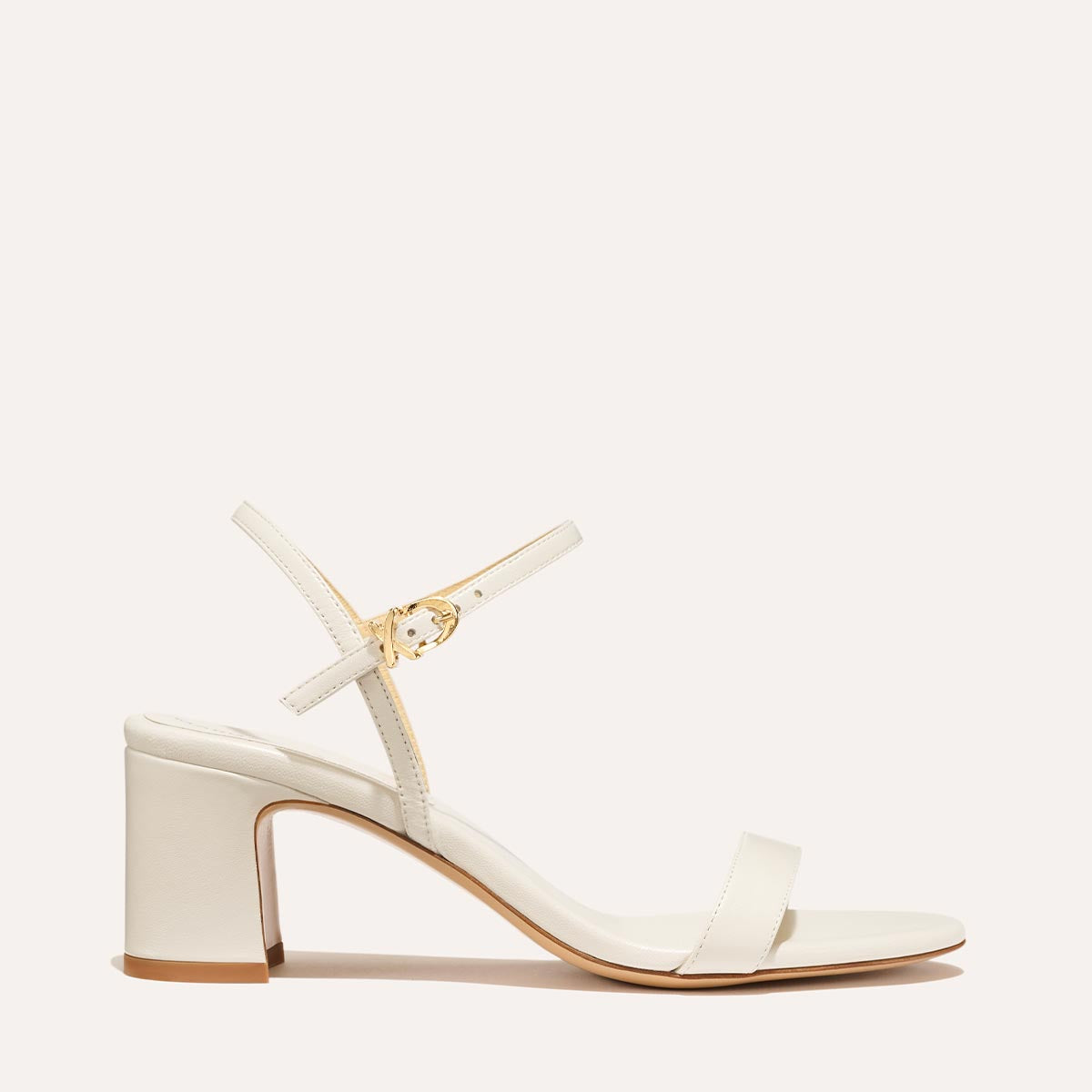 The Cleo Sandal in Ivory Nappa, a comfortable 2.5-inch heeled sandal with a sleek strap across the toes and perfectly placed instep strap.