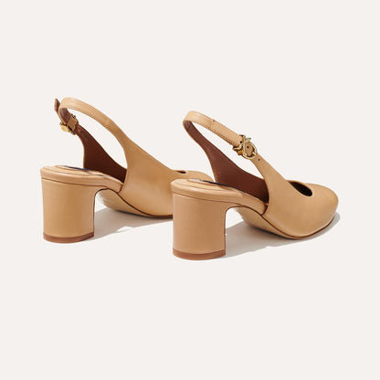 The Cluny Slingback in Dune Nappa, featuring a sleek Italian nappa leather upper with an adjustable buckle and a comfortable 2.5-inch black heel.