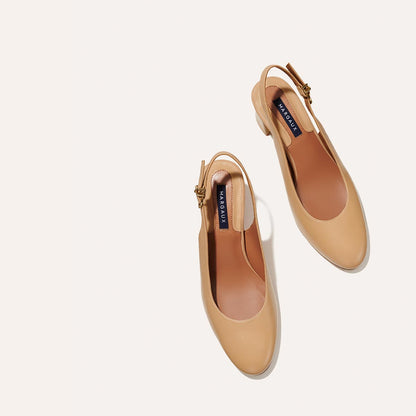 The Cluny Slingback in Dune Nappa, featuring a sleek Italian nappa leather upper with an adjustable buckle and a comfortable 2.5-inch black heel.