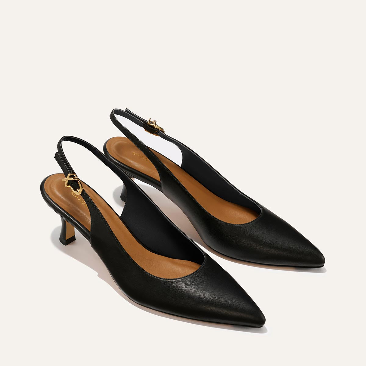 The Colette - Black Nappa by margaux-development: black snip toe slingback heels with low micro heels and tan insoles, shown on a light background.
