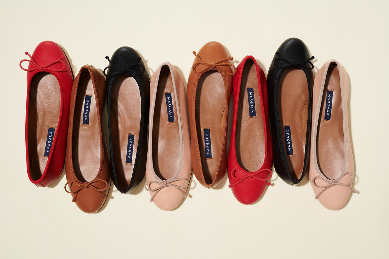 Margaux's bestselling Demi, a classic ballet flat with a rounded toe and bow detail shown in Scarlet, Saddle, Black and Ballet Pink