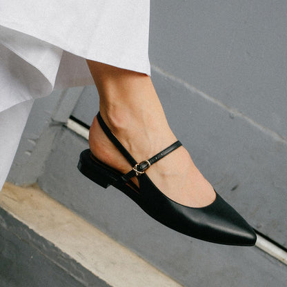 The Cluny Slingback in Black Nappa, a ballet flat with a pointed toe, a slingback strap and an adjustable strap across the top of the foot for a secure fit.