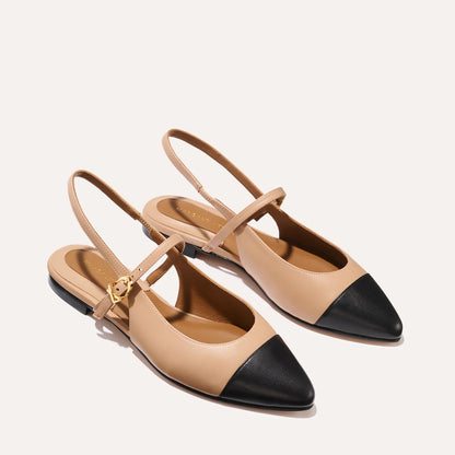 A neutral leather mary-jane flat with a black cap toe