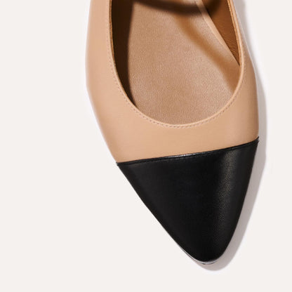 A neutral leather mary-jane flat with a black cap toe