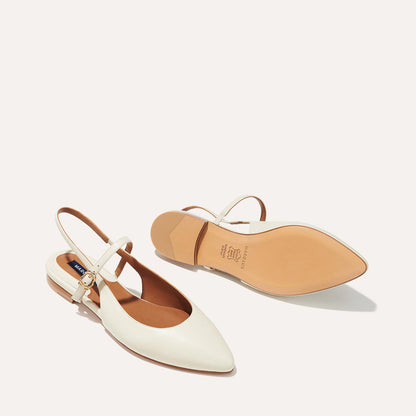 The Cluny Slingback in Ecru Nappa, a ballet flat with a pointed toe, a slingback strap and an adjustable strap across the top of the foot for a secure fit.
