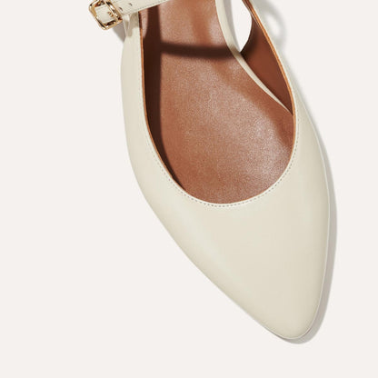 The Cluny Slingback in Ecru Nappa, a ballet flat with a pointed toe, a slingback strap and an adjustable strap across the top of the foot for a secure fit.