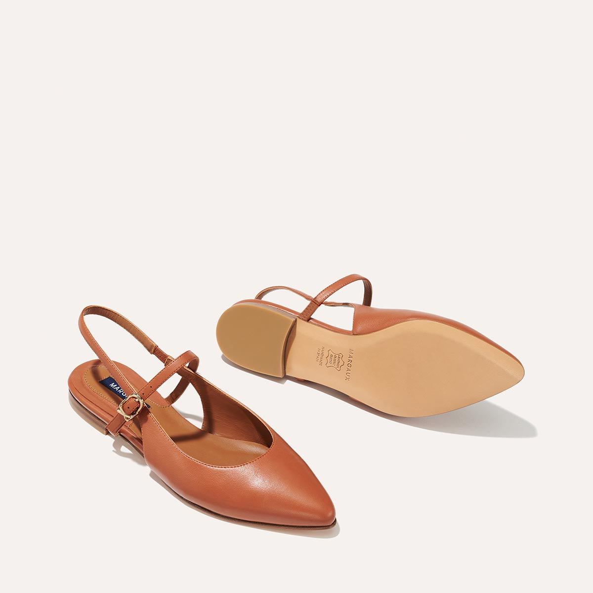 The Cluny Slingback in Saddle Nappa, a ballet flat with a pointed toe, a slingback strap and an adjustable strap across the top of the foot for a secure fit.