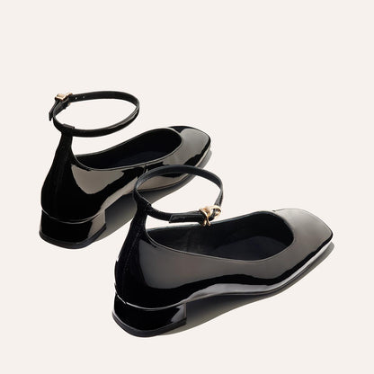 The Daphne in Black Patent, featuring a chic square toe, a supportive ankle strap and a versatile 1-inch block heel,